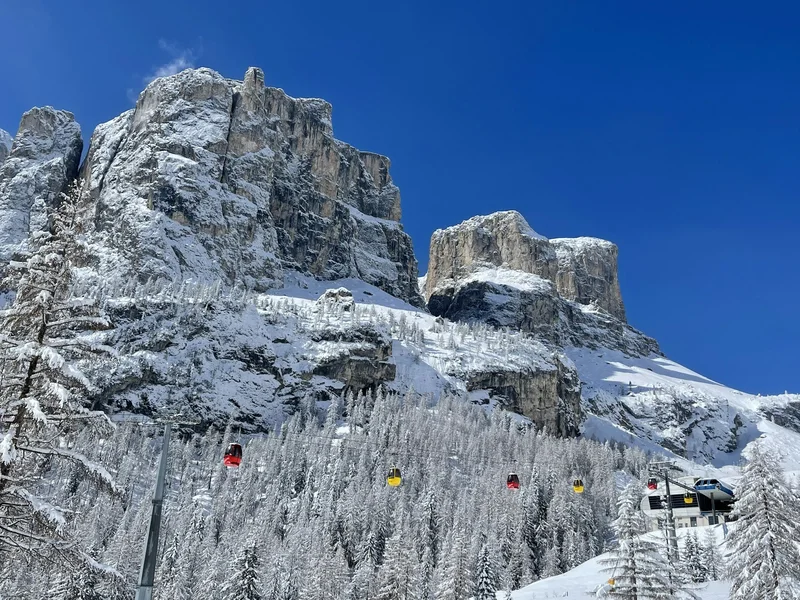 Snow-covered Dolomites and gondola lift at Colfosco