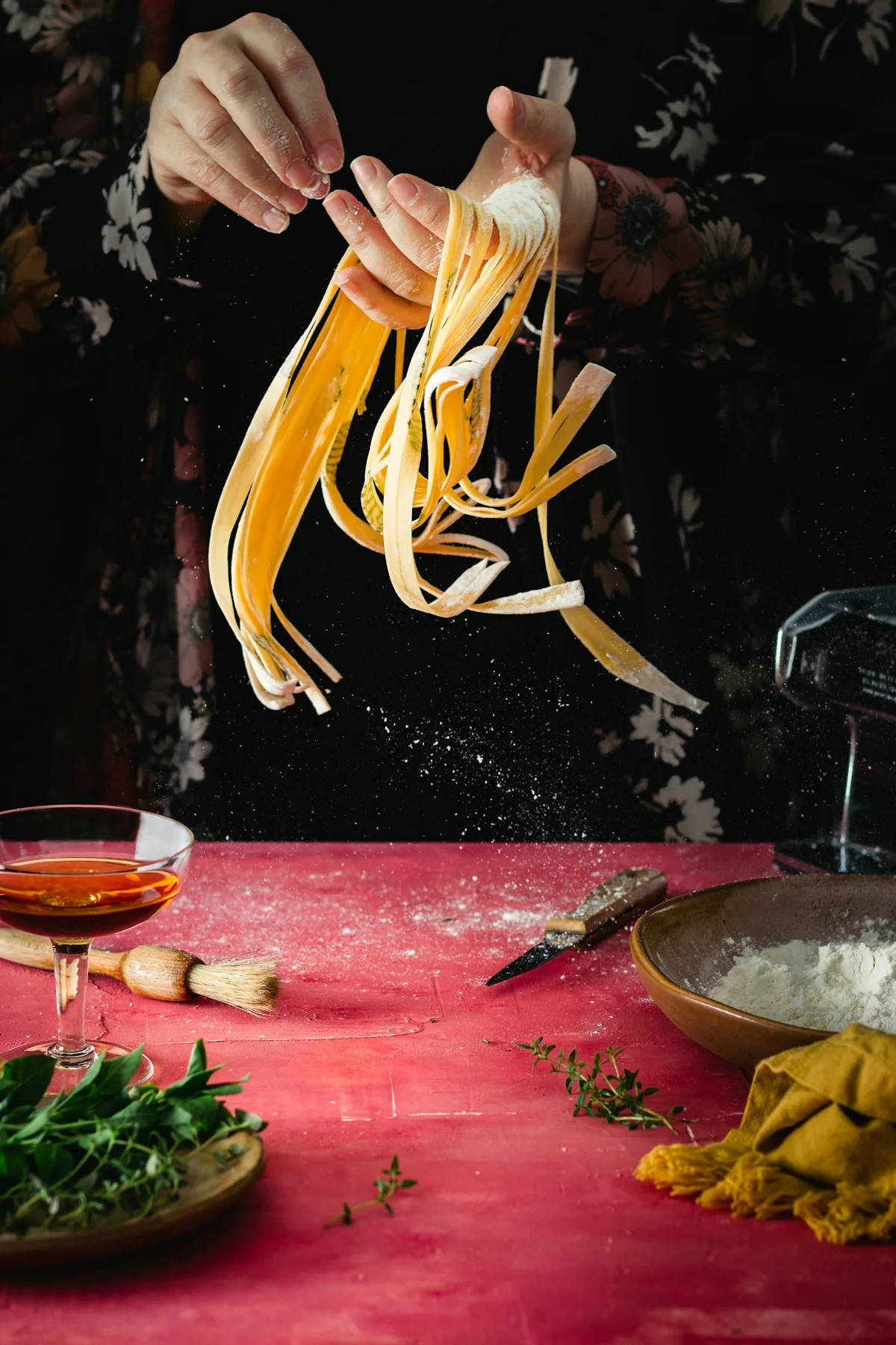 Hands shaping fresh pasta ribbons