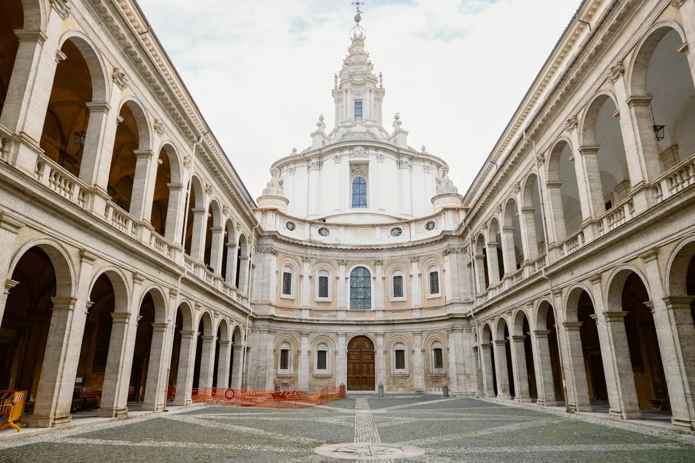 A historic courtyard and church dome in Rome